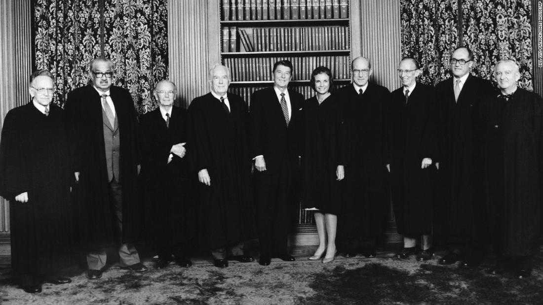 In this photo provided by the White House, the nine justices of the Supreme Court, including the newly sworn-in Sandra Day O&#39;Connor, pose with President Reagan in the conference room of the Supreme Court on September 25, 1981. From left are Harry A. Blackmun, Thurgood Marshall, William J. Brennan, Chief Justice Warren Burger, President Reagan, O&#39;Connor, Byron White, Lewis Powell, William Rehnquist and Stevens. 