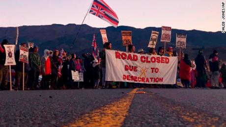 Demonstrators gather to block a road at the base of Hawaii&#39;s tallest mountain, Monday, July 15, 2019.