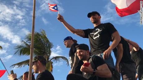 Ricky Martin waves a small Puerto Rican flag as he joined the protest in Puerto Rico. 