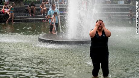 NEW YORK, NY - JULY 17: A woman cools off in the fountain at Washington Square Park during a hot afternoon day on July 17, 2019 in New York City. Sweltering heat is moving into the New York City area, with temperatures expected to rise close to 100 degrees by this weekend. The large heat wave will affect close to two thirds of the United States, with the East Coast and Midwest seeing the worst conditions. (Photo by Drew Angerer/Getty Images)