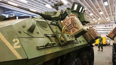 Tens of trucks, tanks, armored vehicles, hovercrafts and amphibious vehicles are stored in the belly of the ship.