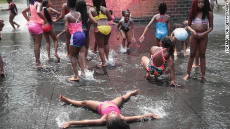 Children cool off in downtown Chicago during heat wave in July 2019. 