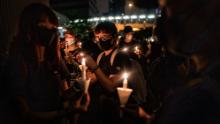 Mourners hold candles during a candlelight vigil to commemorate a protestor who died last night during a rally against a controversial extradition law proposal on June 17, 2019 in Hong Kong, China. 