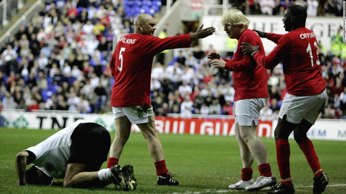Johnson looks apologetic after fouling Germany&#39;s Maurizio Gaudino during a charity soccer match in Reading, England, in May 2006.