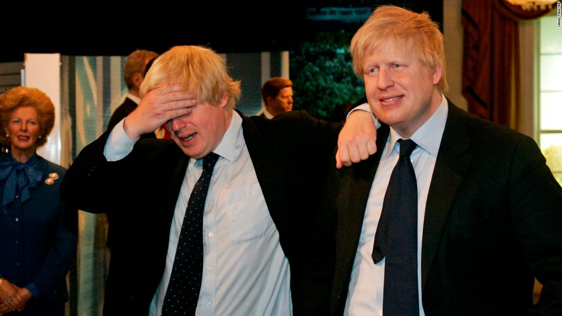 Johnson, left, poses with a wax figure of himself at Madame Tussauds in London in May 2009.