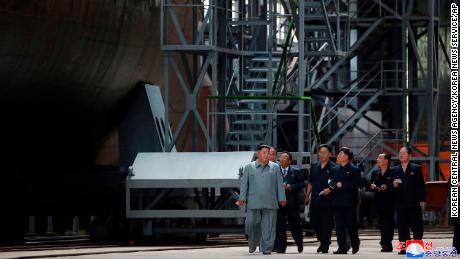 Kim Jong Un seen beside apparent submarine in state media photographs