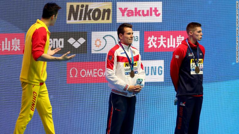 Gold medalist Sun Yang of China (left) and bronze medalist Duncan Scott of Great Britain (right) interact during the medal ceremony for the Men&#39;s 200m Freestyle Final.