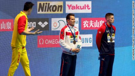 Gold medalist Sun Yang of China (left) and bronze medalist Duncan Scott of Great Britain (right) interact during the medal ceremony for the Men&#39;s 200m Freestyle Final.