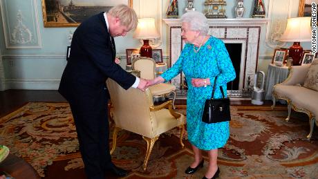 Britain&#39;s Queen Elizabeth II welcomes newly elected leader of the Conservative party Boris Johnson during an audience at Buckingham Palace, London, Wednesday July 24, 2019, where she invited him to become Prime Minister and form a new government. (Victoria Jones/Pool via AP)