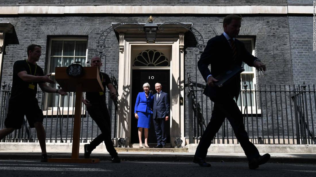 May and her husband, Philip, stand in front of No. 10 Downing Street before delivering her resignation to Queen Elizabeth II.