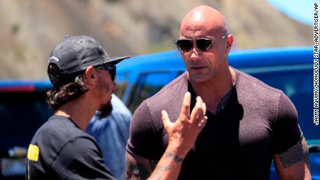 Actor Dwayne &quot;The Rock&quot; Johnson, right, talks with TMT opposition leader Kaho&#39;okahi Kanuha during a visit to the protests against the TMT telescope, Wednesday, July 24, 2019, at the base of Mauna Kea on Hawaii Island. (Jamm Aquino/Honolulu Star-Advertiser via AP)