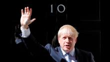 Britain's new Prime Minister Boris Johnson waves from the steps outside 10 Downing Street, London, Wednesday, July 24, 2019. Boris Johnson has replaced Theresa May as Prime Minister, following her resignation last month after Parliament repeatedly rejected the Brexit withdrawal agreement she struck with the European Union. (AP Photo/Frank Augstein)