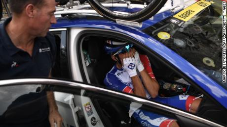 France&#39;s Thibaut Pinot, in his team car, reacts after quitting the Tour de France.