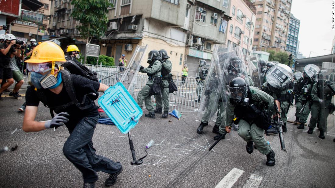 A protester flees from baton-wielding police in the Yuen Long district of Hong Kong on Saturday, July 27.