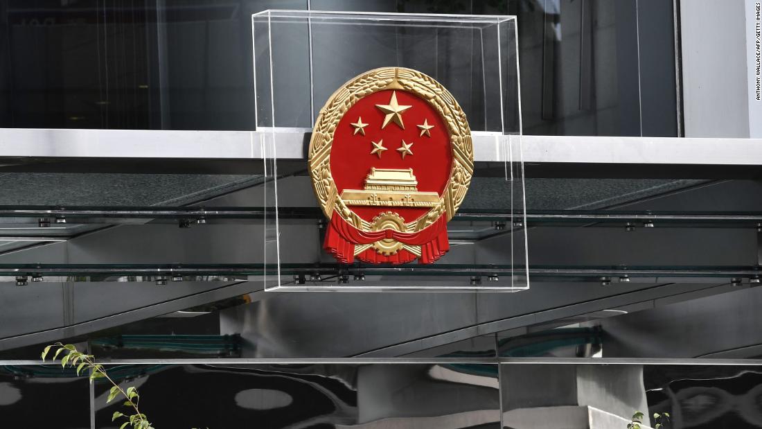 The emblem on the China Liaison Office is protected by plexiglass during a demonstration on Sunday, July 28.