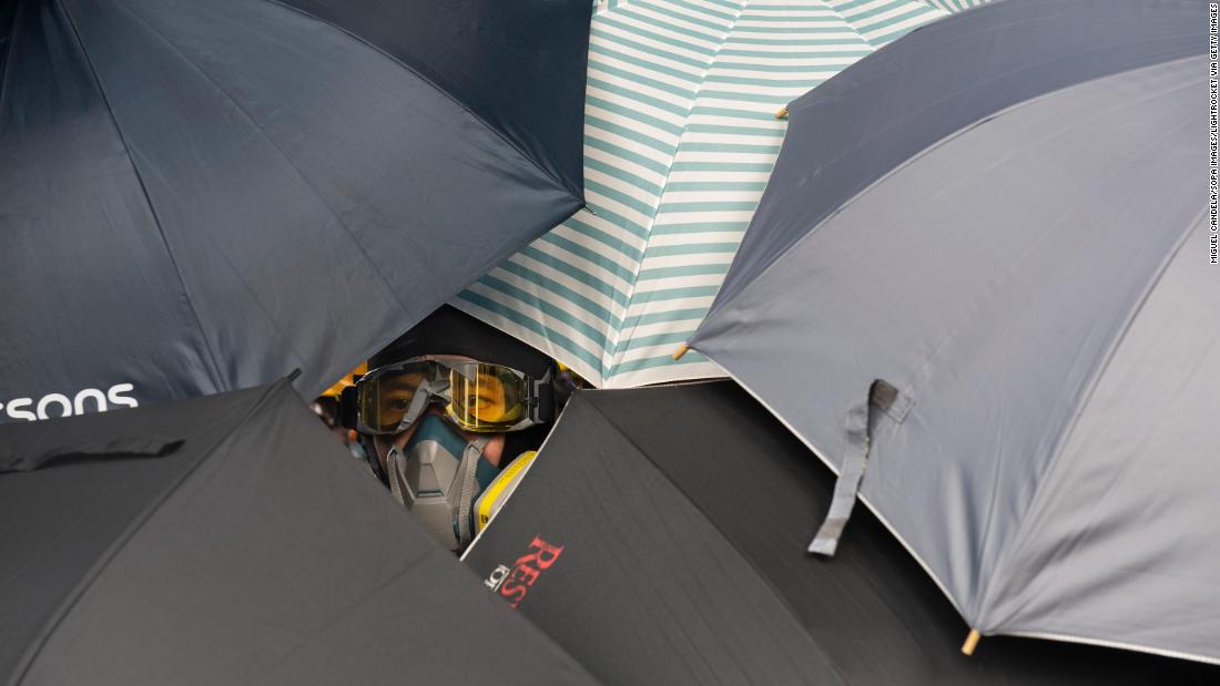 A protester looks through umbrellas during the clashes with police on July 27.