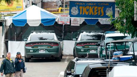 FBI personnel pass a ticket booth at the Gilroy Garlic Festival Monday, July 29, 2019 in Calif., the morning after a gunman killed at least three people, including a 6-year-old boy, and wounding about 15 others.  A law enforcement official identified the gunman, who was shot and killed by police, as Santino William Legan. (AP Photo/Noah Berger)