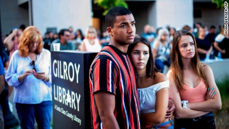 Derrick Smith, left, embraces Sara Sakamoto during a vigil for victims of Sunday&#39;s deadly shooting at the Gilroy Garlic Festival on Monday, July 29, 2019.