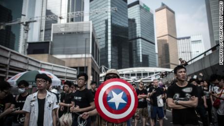 Pro-democracy protesters, including one carrying a shield from the &quot;Captain America&quot; comic book series stand their ground during protests in Hong Kong on October 4, 2014.