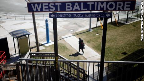 A woman walks from the West Baltimore train station on March 26, 2018. 