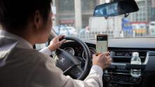 In this picture taken on October 18, 2018, a driver working for ride-sharing company Didi follows a map on his smartphone to bring a customer to his destination in Beijing. - Didi is a popular taxi and ride-sharing service in China that is operated via a smartphone app. (Photo by Nicolas ASFOURI / AFP)        (Photo credit should read NICOLAS ASFOURI/AFP/Getty Images)