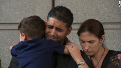 Juan Rodriguez holds one of his children next to his wife Thursday during a news conference following a brief court appearance in the Bronx.