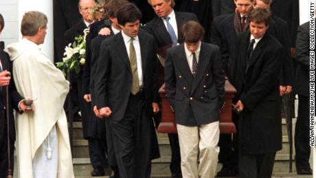 Family members carry the  coffin of Michael Kennedy from church following his death in a skiing accident.  