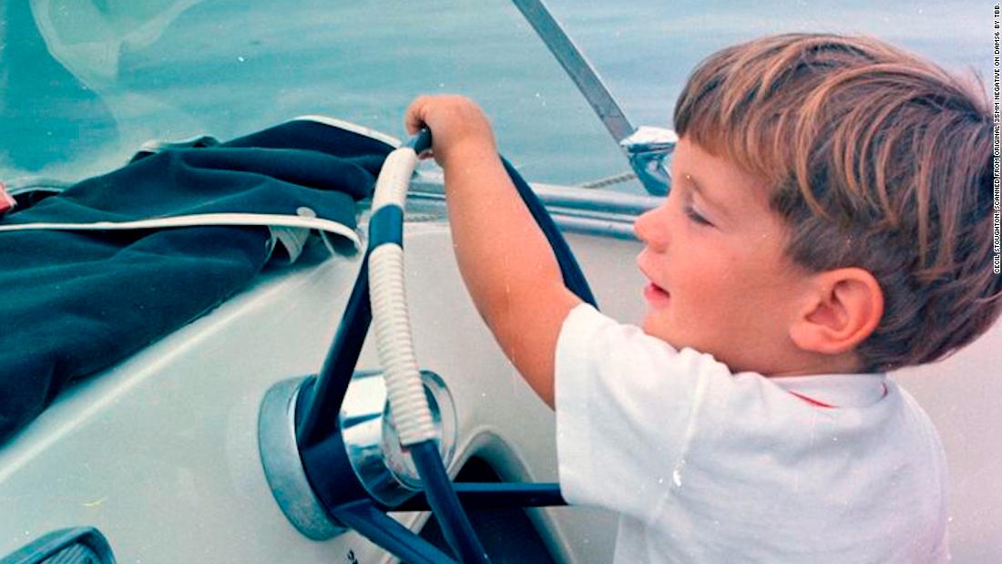 John Jr. takes the wheel of a speedboat during Labor Day weekend in 1963.