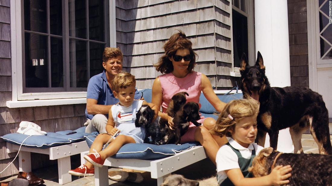 John and Jackie, joined by Caroline and John Jr., play with dogs in 1963.