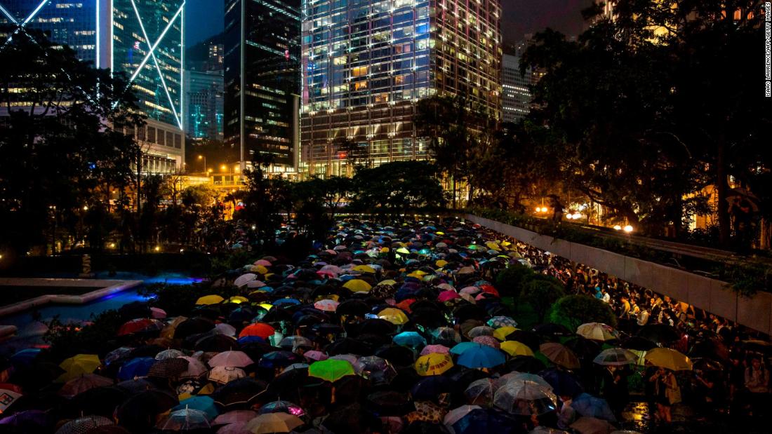 People from the finance community hold up umbrellas and shine lights during a protest against a controversial extradition bill in Hong Kong on August 1.