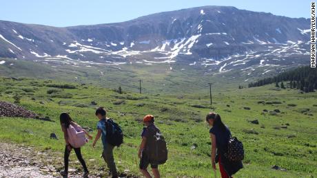 A group of 8- and 9-year-olds trudges up a mountain as part of a program through Get Outdoors Leadville! 