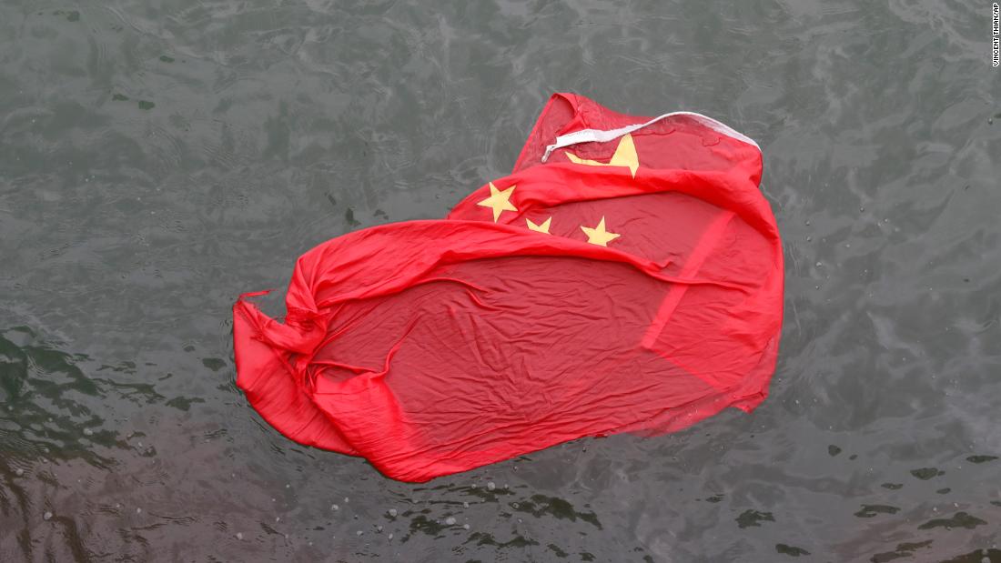 A Chinese flag floats in water after it was thrown by protesters during a demonstration on Saturday, August 3.