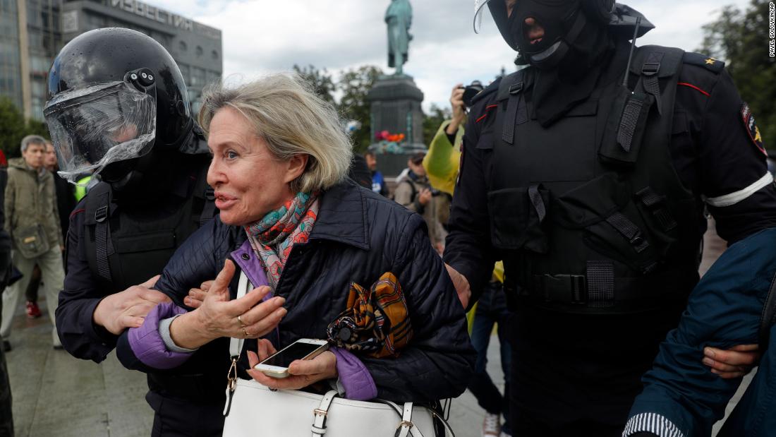 Police officers detain a woman during an unsanctioned rally in central Moscow on Saturday. 