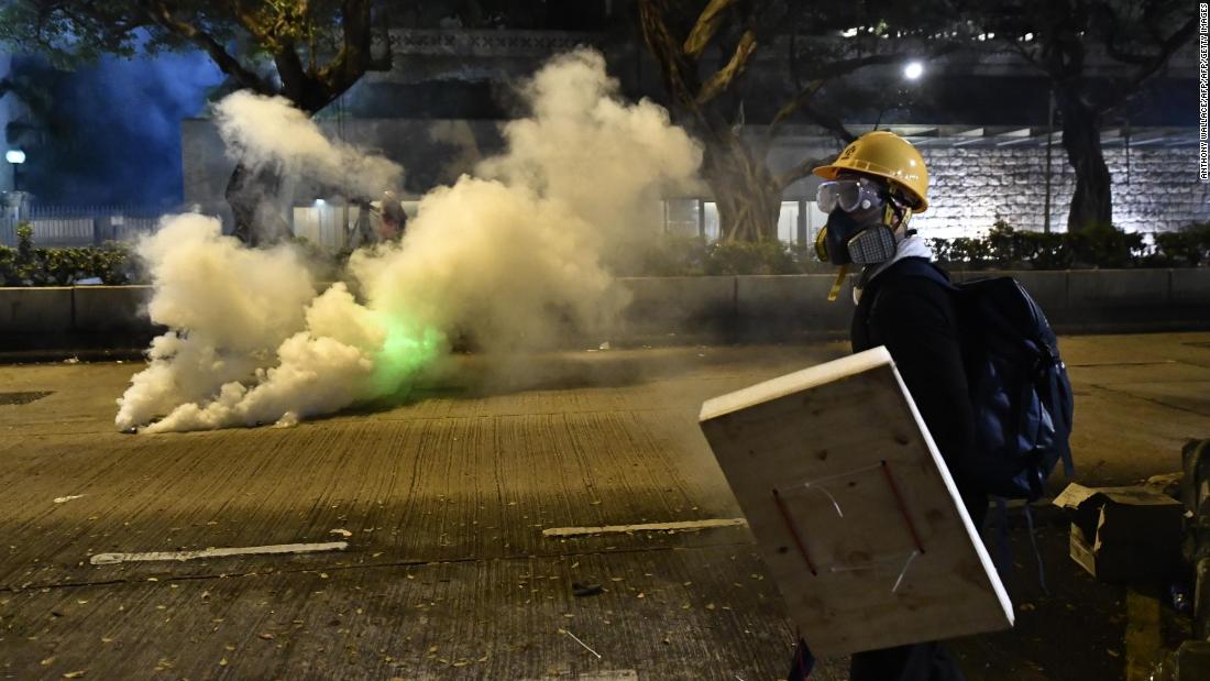 A protester holds a makeshift shield outside the Tsim Sha Tsui police station in Hong Kong on Saturday.