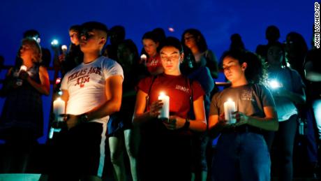 From left, Samuel Lerma, Arzetta Hodges and Desiree Quintanar attend a vigil for victims of the deadly shooting that occurred earlier in the day.