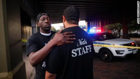 Witnesses comfort one another at the scene of a mass shooting in Dayton, Ohio.