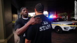 Witnesses comfort one another at the scene of a mass shooting in Dayton, Ohio.