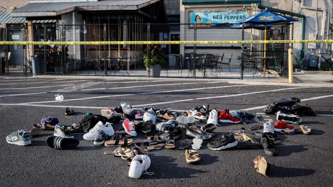 Shoes, hats and other items are piled together outside a bar in Dayton on Sunday.