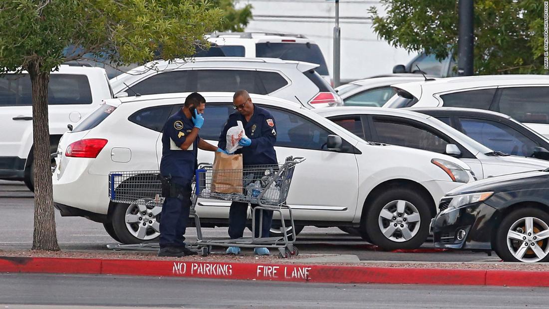 Police conduct their investigation in the parking lot of an El Paso Walmart on Sunday.