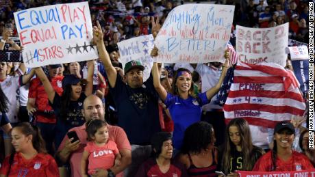 PASADENA, CALIFORNIA - AUGUST 03: Fans hold signs during the game between the Republic of Ireland and the United States in the first game of the USWNT Victory Tour at Rose Bowl on August 03, 2019 in Pasadena, California. (Photo by Harry How/Getty Images)