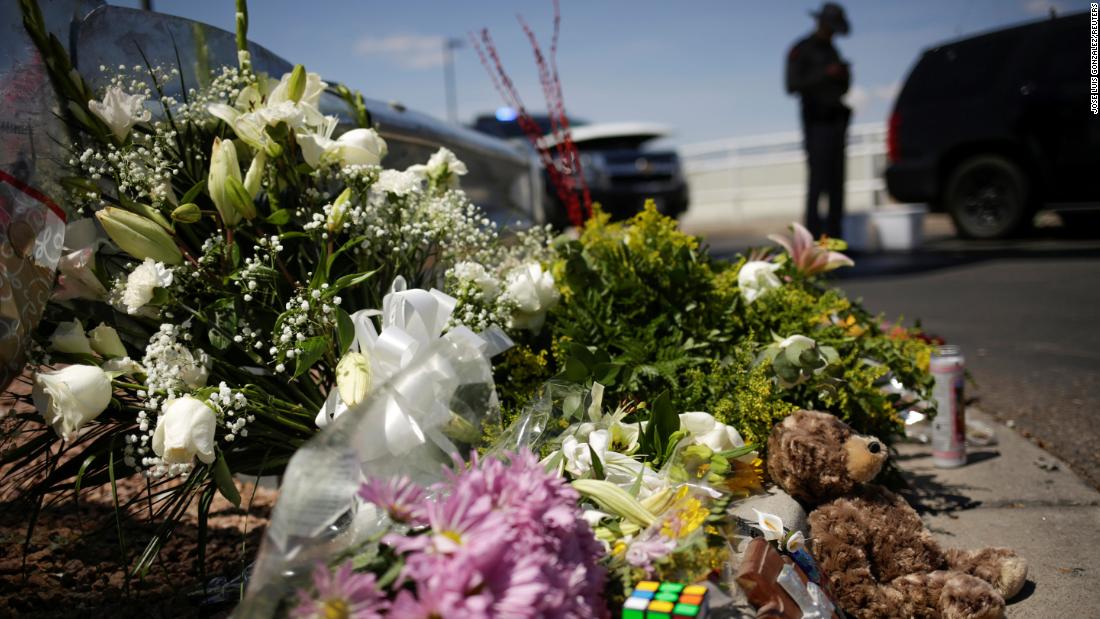 Flowers left by mourners lie near the site of the shooting in El Paso.