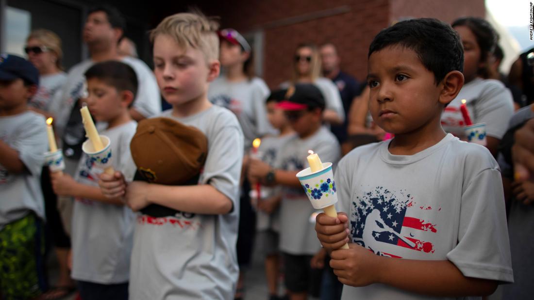 Children participate in an El Paso vigil Sunday.