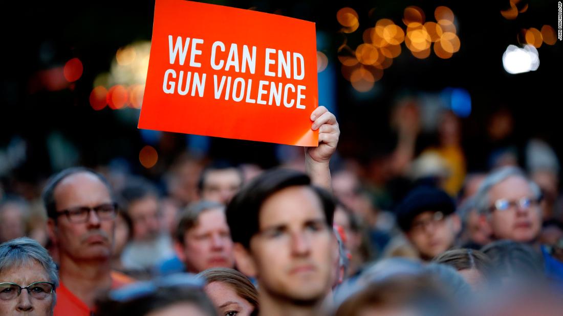 Someone holds up a sign during the vigil in Dayton.