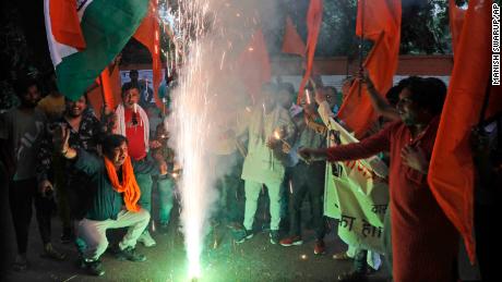 Right wing Hindu groups light firecrackers as they celebrate the removal of Kashmir&#39;s special constitutional status in New Delhi. 