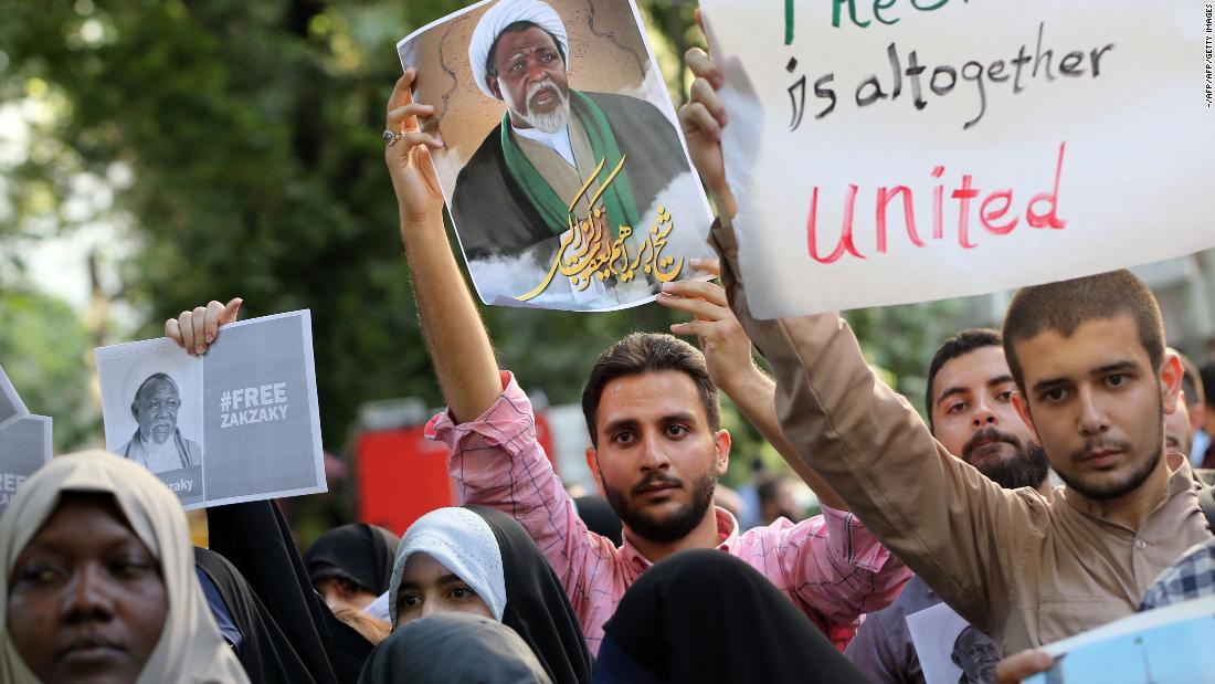 Iranians and Nigerian students hold Zakzaky's posters during a demonstration for his release outside the Nigerian embassy in Tehran on July 17, 2019. 