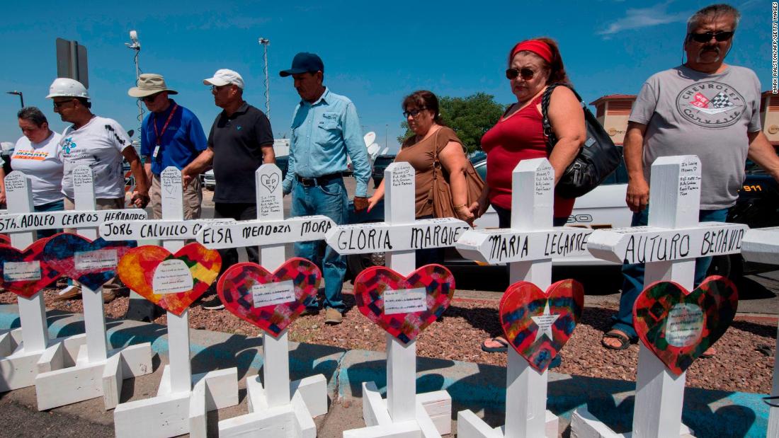 People pray Monday, August 5, at a makeshift memorial for those who died in the mass shooting in El Paso, Texas, on Saturday.