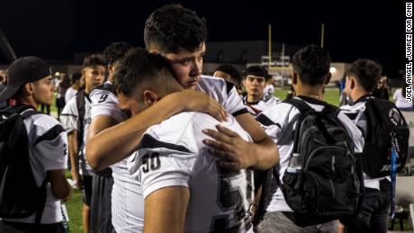 Student Carlos Teran, 16, left, hugs his teammate Humberto Aguilar, 16, after attending a vigil for sophomore Javier Rodriguez, 15, at Horizon High School on Monday. Rodriguez was among the 22 killed in the shooting at a Walmart in El Paso.