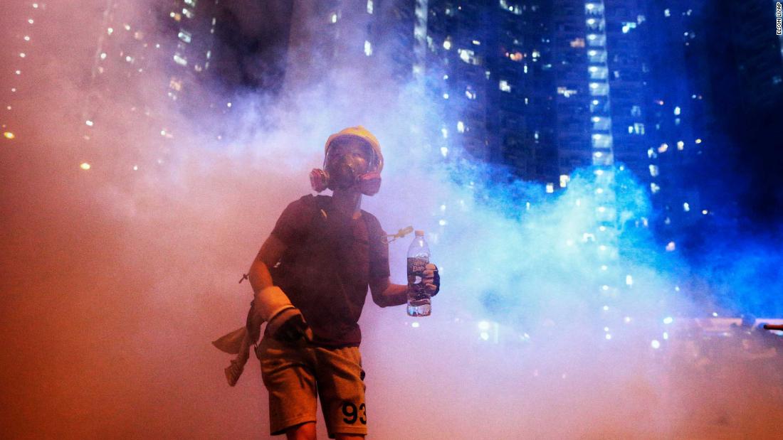 A protester stands in tear gas during a confrontation with police in the early hours of Sunday, August 4.