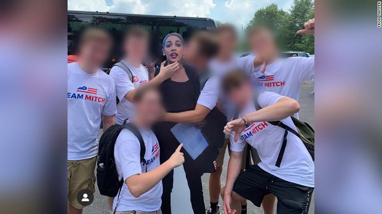 A photo shows a group of young men wearing "Team Mitch" t-shirts -- as sign of support for Senate Majority Leader Mitch McConnell -- appearing to kiss and mock choke a cardboard cutout of Rep. Alexandria Ocasio-Cortez, a Democrat from New York. The original photo was later taken down and the user who posted the photo originally apologized.