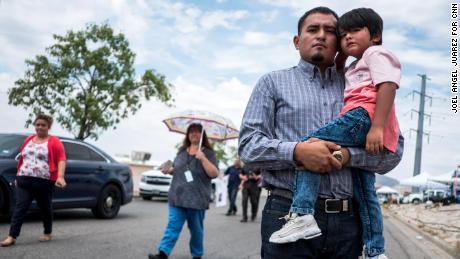 Ivan Flores, 27, poses with his son Derek, 4, near the site of the Walmart shooting in El Paso, Texas.